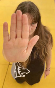 Photo of a woman with her hand held up in a Stop position